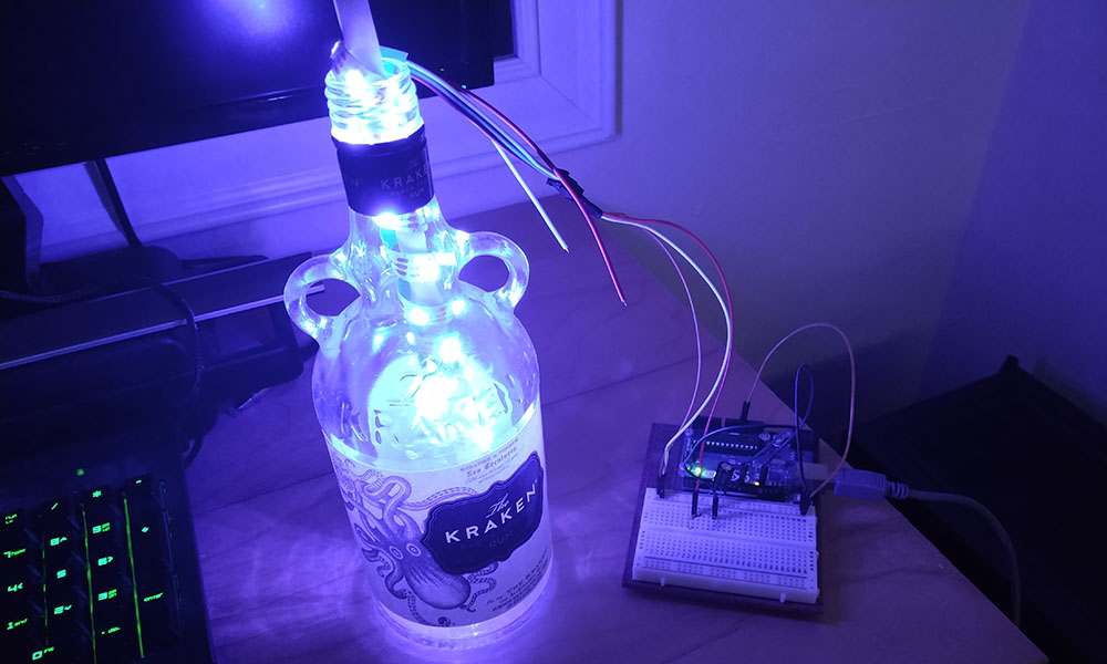 A bottle of Kraken with lights inside powered by an Arduino